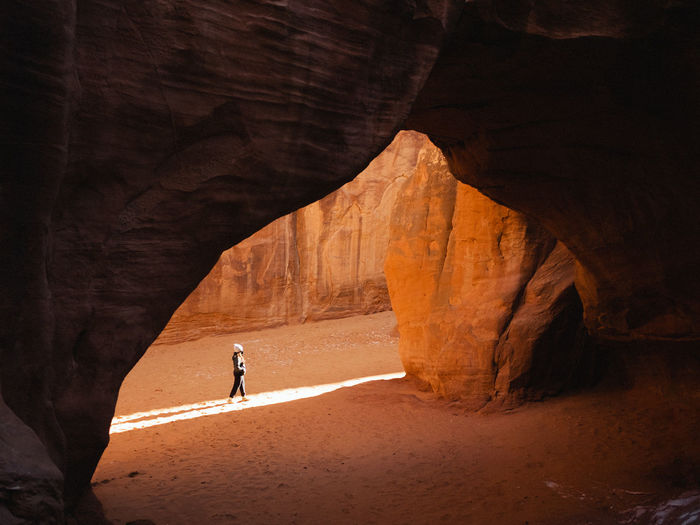 Woman walking under an arch. 