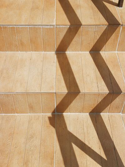 High angle view of shadow on staircase