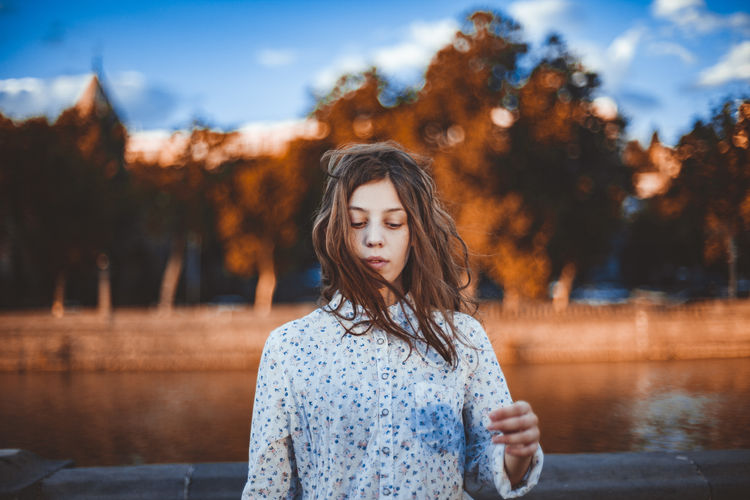 Beautiful Woman Brown Hair Casual Clothing Contemplation Day Focus On Foreground Front View Hair Hairstyle Lake Long Hair Looking Nature One Person Outdoors Portrait Real People Teenager Water Young Adult Young Women Summer Road Tripping The Portraitist - 2018 EyeEm Awards