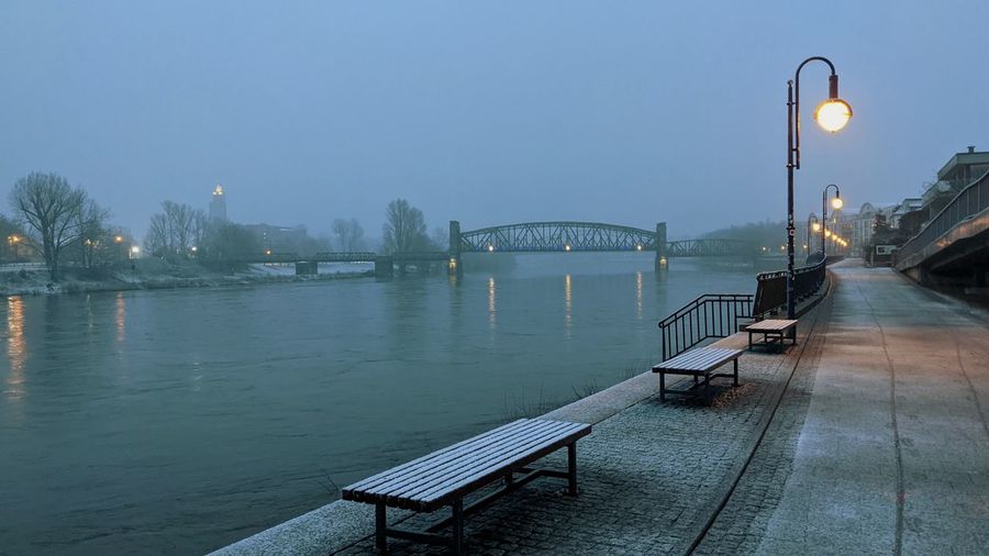 Bridge over river against sky at dusk