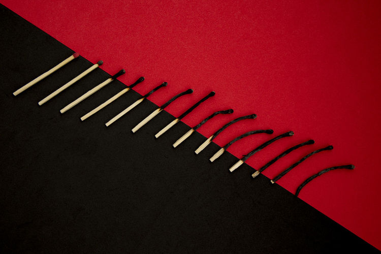 High angle view of piano keys over black background
