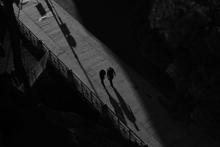 High angle view of silhouette people walking on street at night
