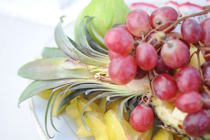 Close-up of various fruits in plate on table
