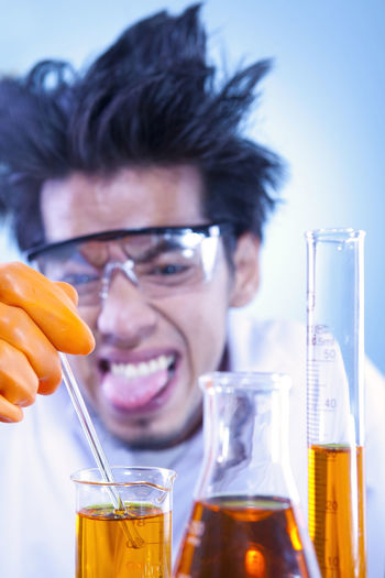 Scientist making face while experimenting at laboratory