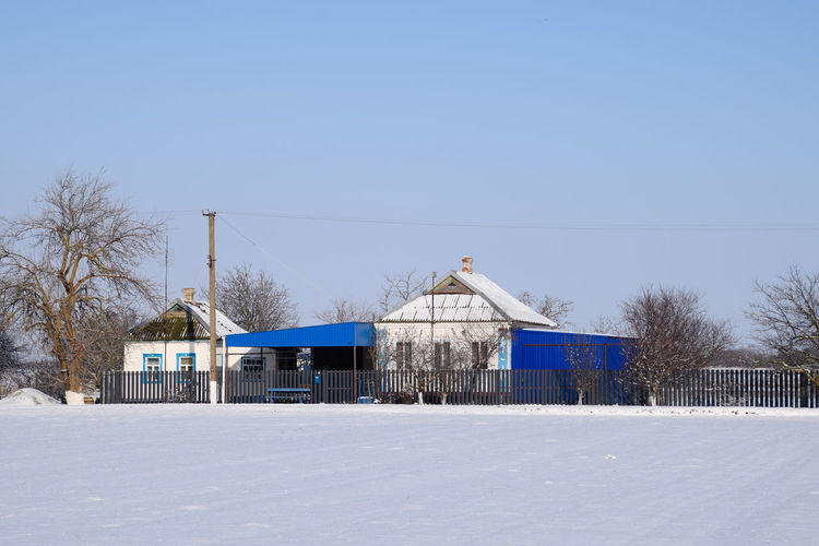 Built structure on snow covered landscape against clear sky