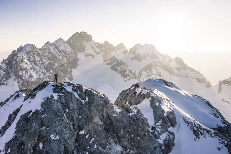 Climber standing on vorderer tajakopf mountain, ehrwald, tirol, austria