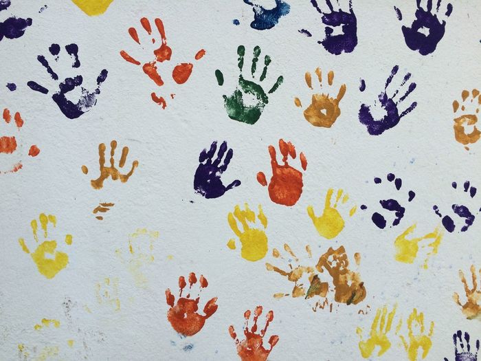 Multi colored handprints on wall