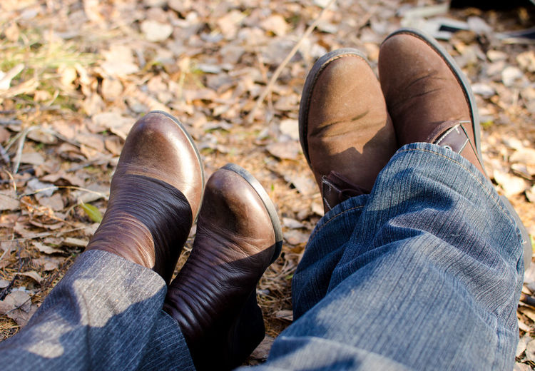 Low section of couple in shoes outdoors
