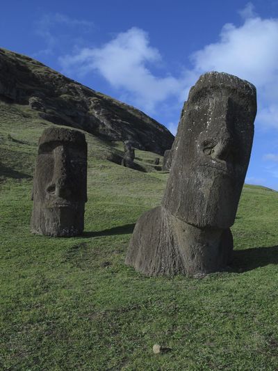 Stone statues on field against sky at rapa nui national park