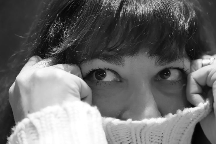 Close-up of thoughtful woman wearing turtleneck
