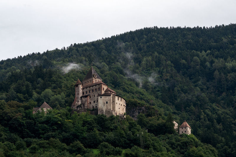 Low angel view of castle on mountain against clear sky