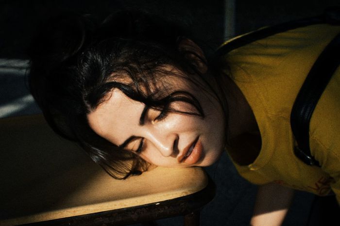 Close-up of woman sleeping on table