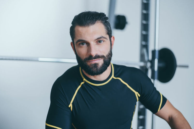Portrait of beautiful sweaty man after training gym session. young sporty boy after work out 