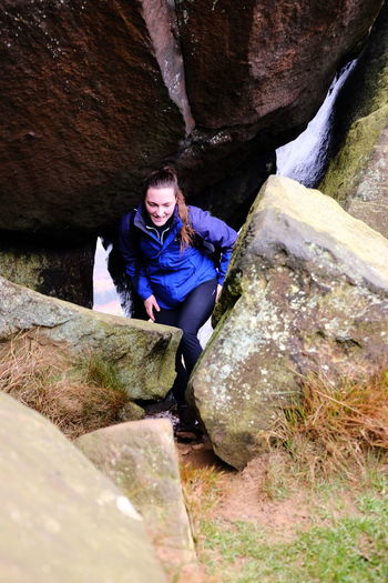 Portrait of woman sitting on rock