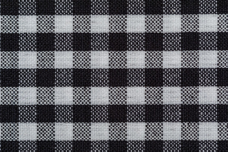 Checkered fabric background. black cell. top view, flat lay.