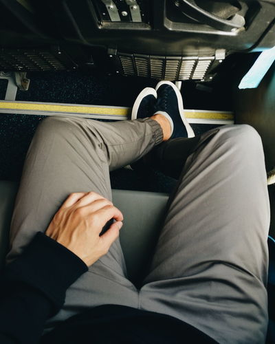 Low section of man sitting in bus