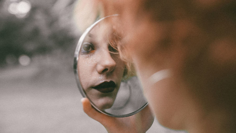 Woman reflecting in mirror