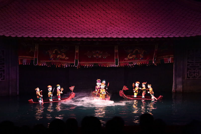 Puppets in boat on water