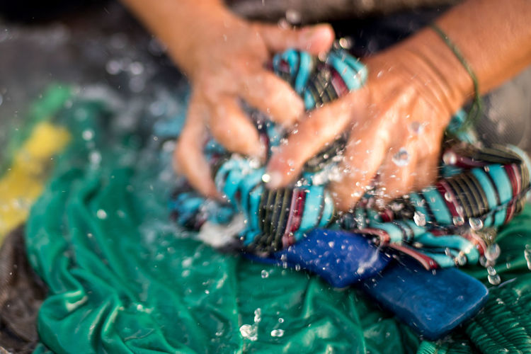 High angle view of woman holding hands in water