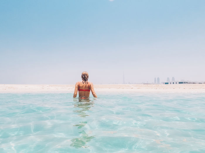 Woman walking towards the beach