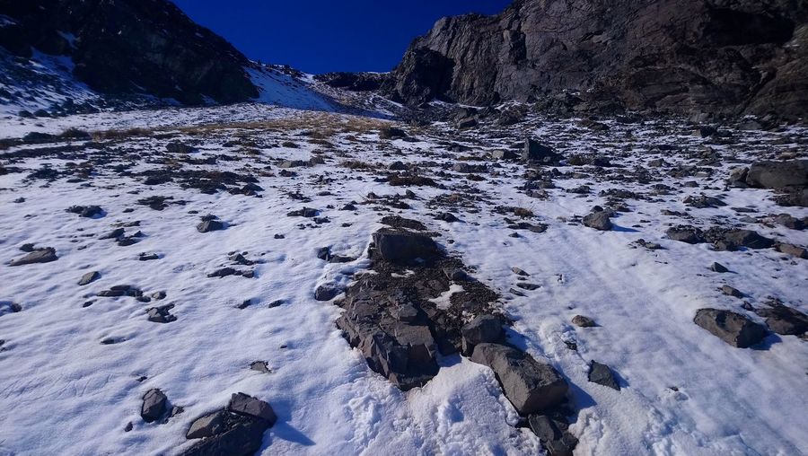 Snow covered rocks on land