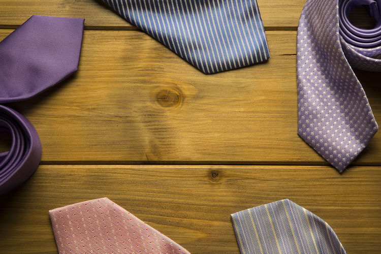 High angle view of colorful neckties on wooden table