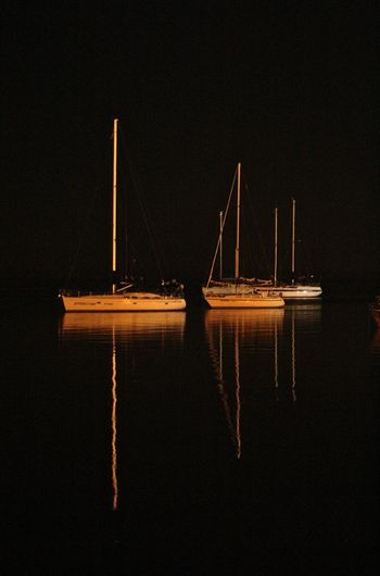 Sailboat in sea at night