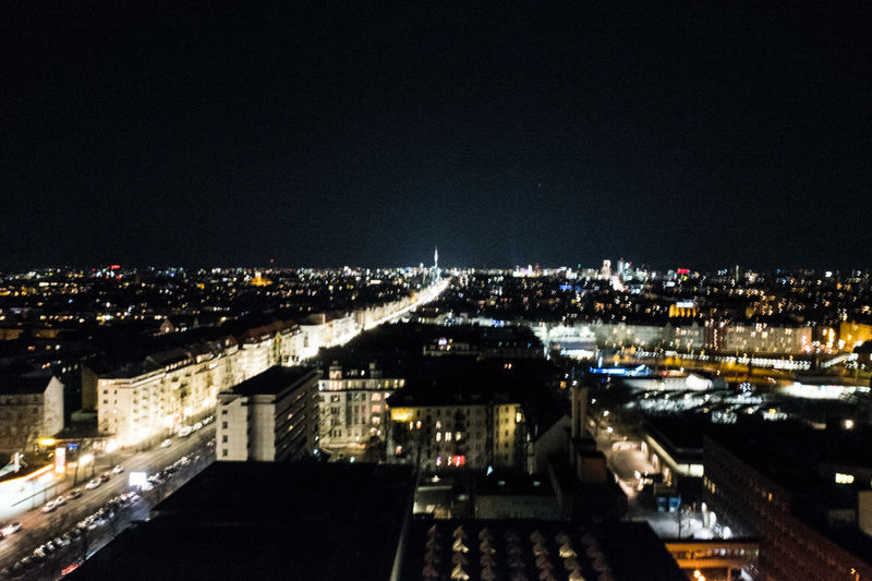 Illuminated cityscape against sky at night