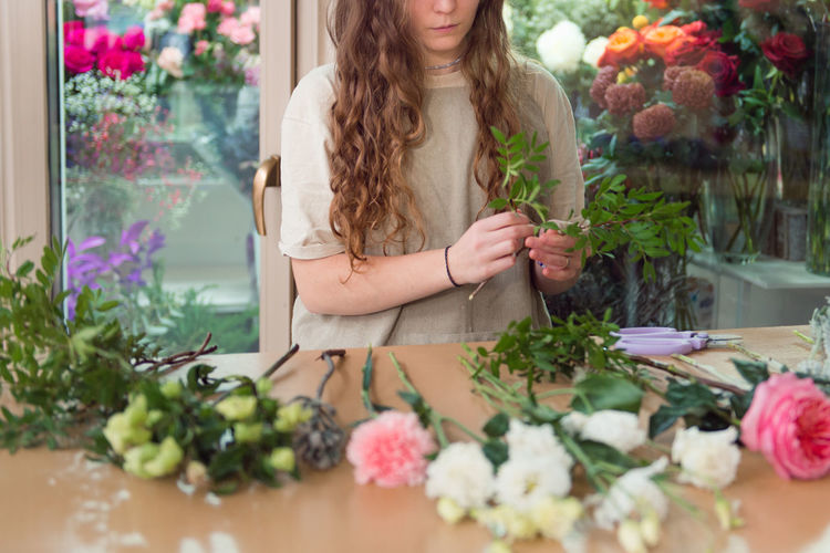 Midsection of florist working in flower shop