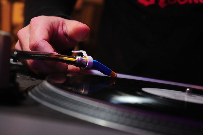 Cropped hand of person touching turntable