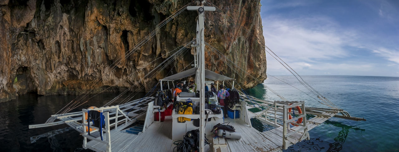 A dive boat moored in the shelter of a cave on gato island near malapascua in the philippines