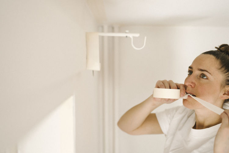 Woman preparing room for painting