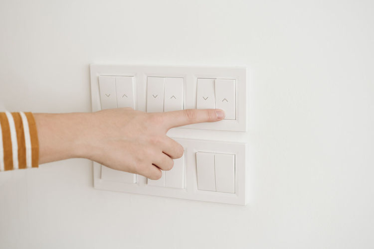 Finger touching switch for blinds on the wall
