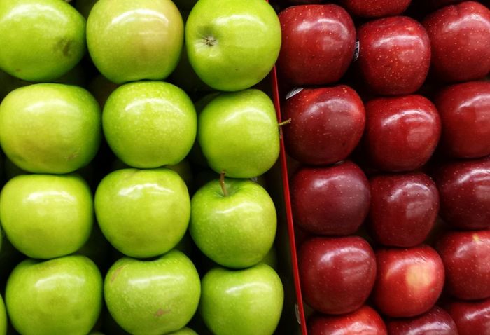 Full frame shot of green and red apple displayed for sale