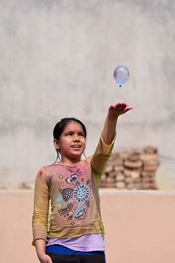 Girl playing with water bomb during holi