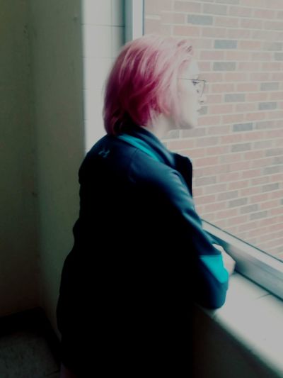 Rear view of woman standing against wall