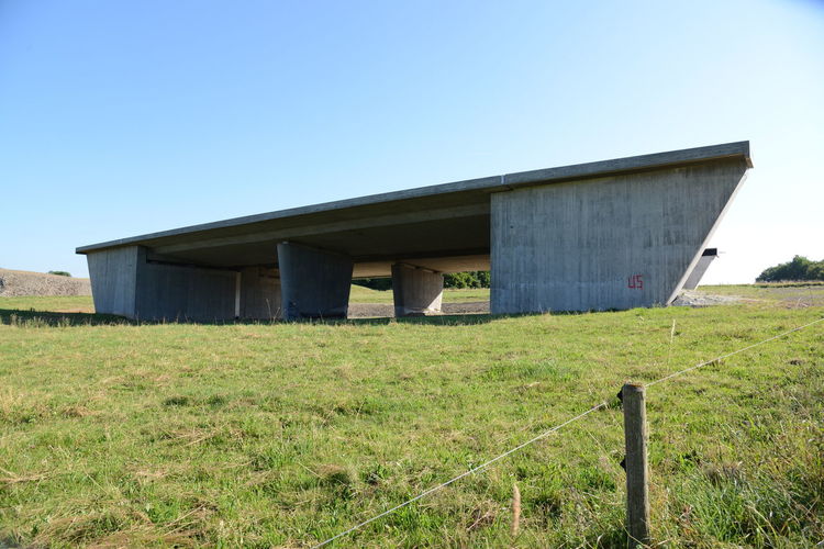 Built structure on field against clear sky