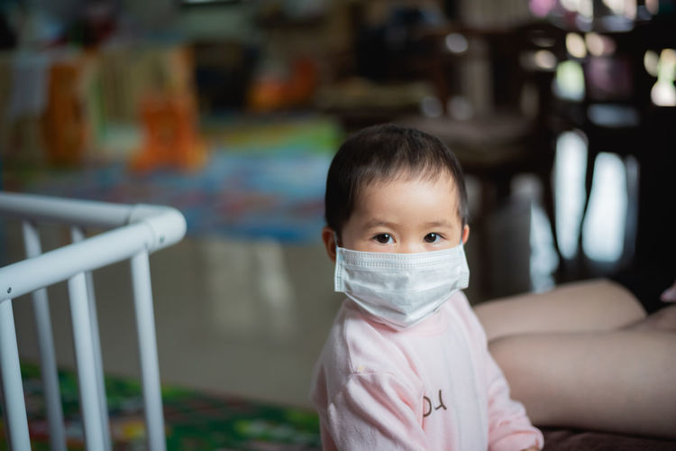 Portrait of baby girl wearing mask