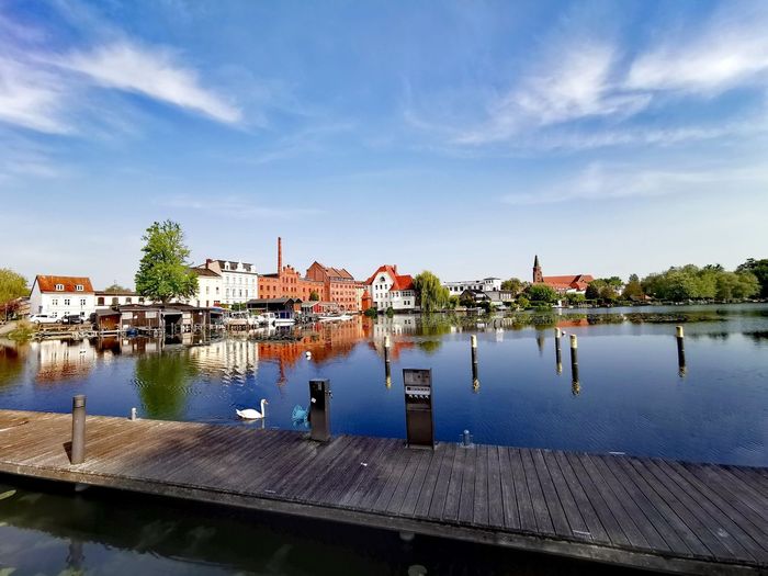 River by buildings against sky