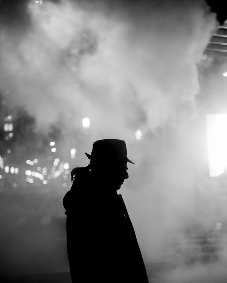 Silhouette man standing against sky