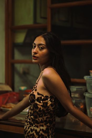 Portrait of young woman sitting at home
