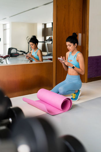 Portrait of young woman exercising in gym