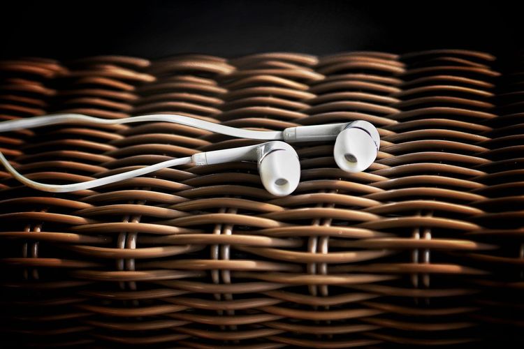 Close-up of headphones on wicker basket
