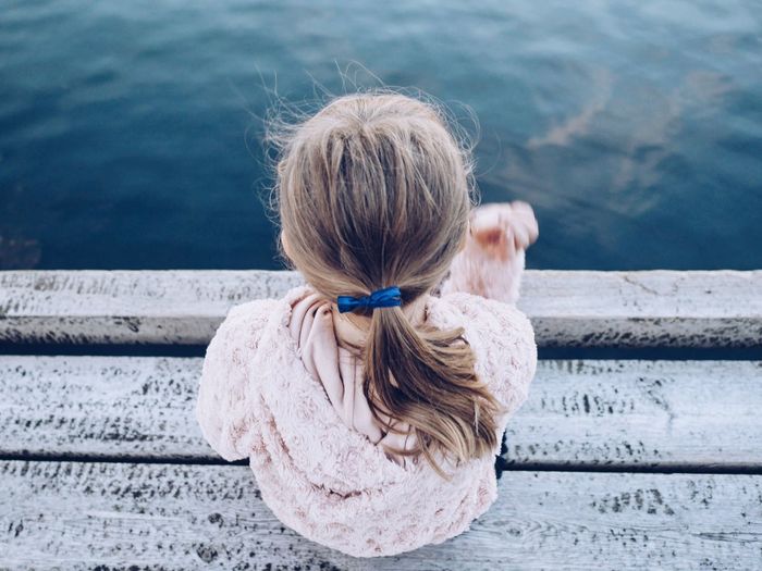 High angle view of girl looking at sea