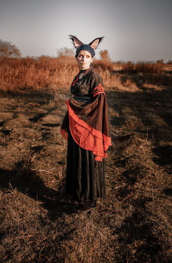 Full length of woman wearing costume standing on field