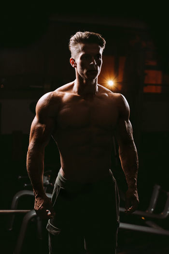 Shirtless man exercising at home