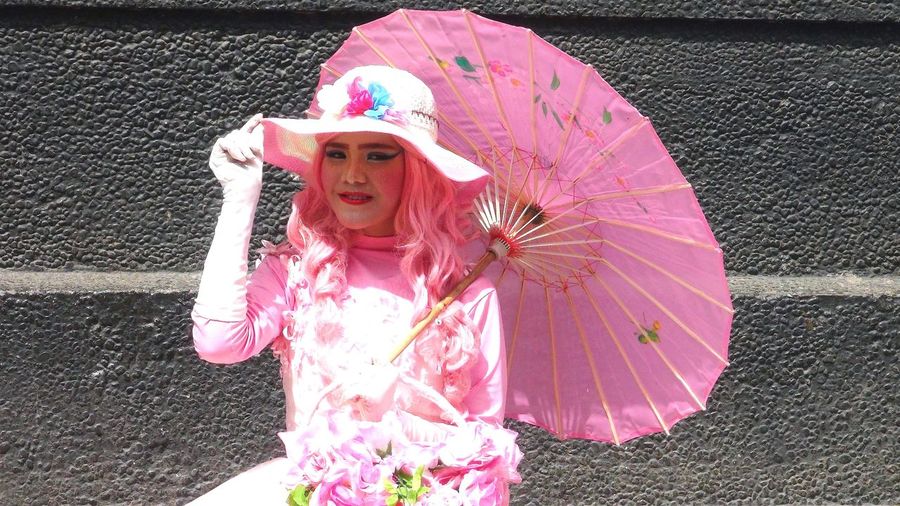 Woman on multi colored umbrella