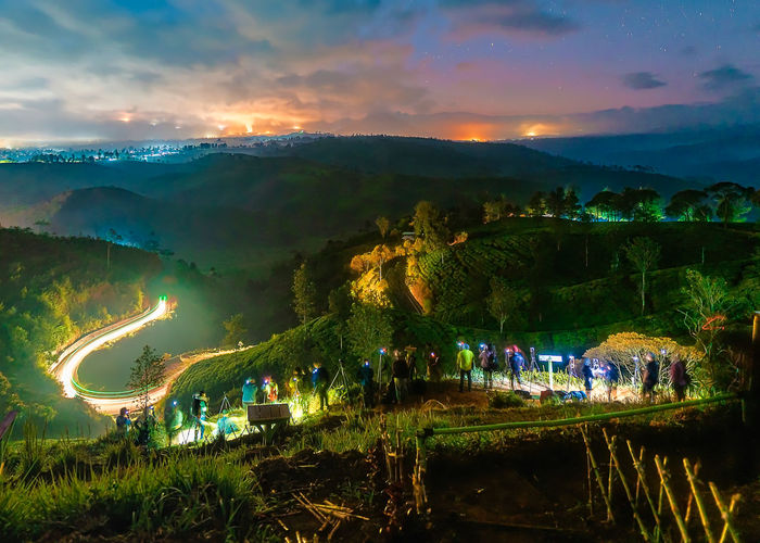 Panoramic view of illuminated landscape against sky at night