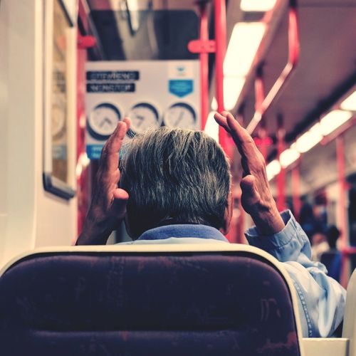 Rear view of man on subway