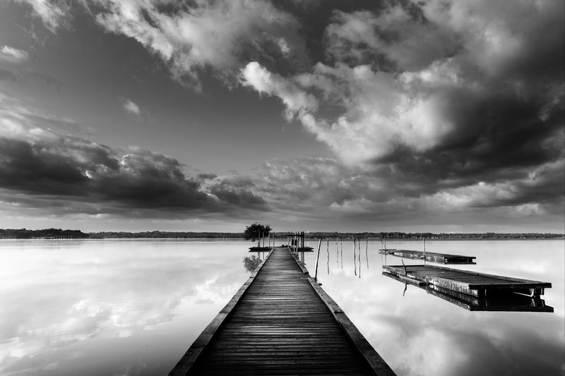 Pier over lake against sky